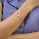  Wholesale 1.30 carat alternating baguette and round diamond bracelet in 18 karat white gold for luxury retail inventory.