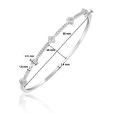 Front view of 18kt gold diamond flower bangle bracelet AB035, continuous pavé diamond row with four raised flower cluster motifs along top half of band, F–G VS clarity natural diamonds