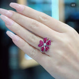 Invisible set ruby orchid ring worn on hand showing vibrant red ruby colour in white gold