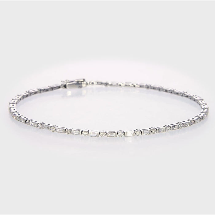 18KT white gold line bracelet showing precision bar-set baguette diamonds flanked by round brilliant diamonds with a visible 750 gold hallmark on the clasp.