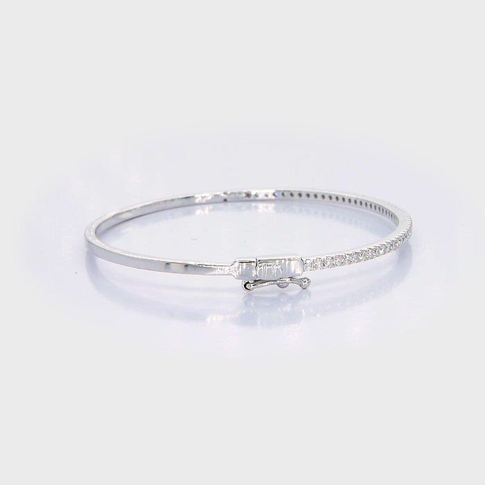 18kt white gold pavé diamond bangle bracelet rotating 360 degrees showing diamond brilliance and hinged clasp, custom fine jewellery manufacturing
