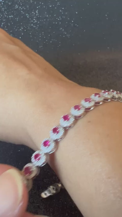 Video showcase demonstrating the light performance and sparkle of calibrated diamond halos on ruby tennis bracelet SKU-AB122.